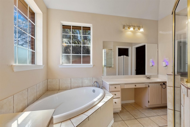 full bath with tile patterned flooring, vanity, a bath, and a shower with door