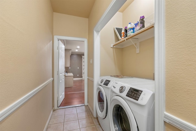 laundry room with light tile patterned floors, laundry area, and separate washer and dryer