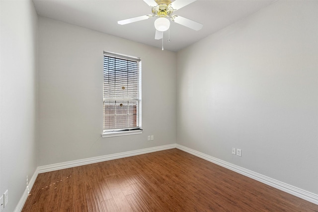 empty room featuring wood finished floors, a ceiling fan, and baseboards