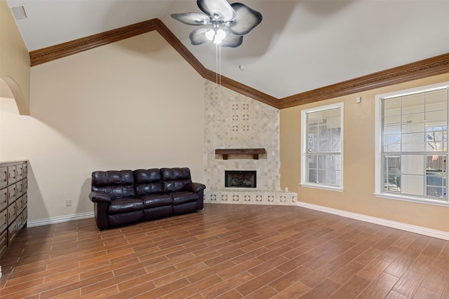 living room featuring high vaulted ceiling, wood finished floors, visible vents, a ceiling fan, and a tiled fireplace