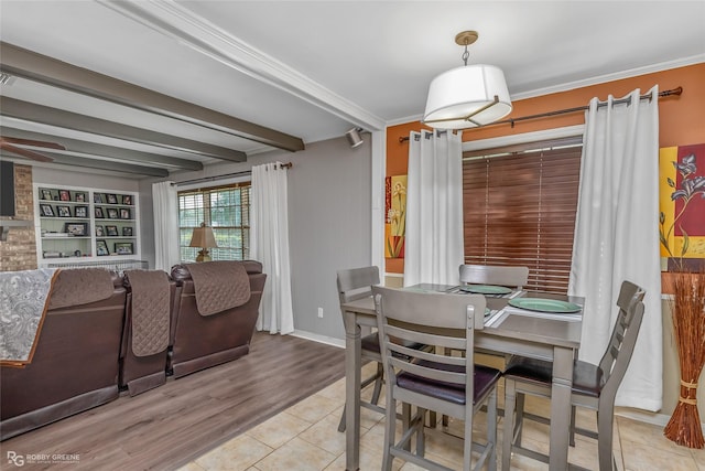 dining room with baseboards, built in features, tile patterned floors, beamed ceiling, and crown molding