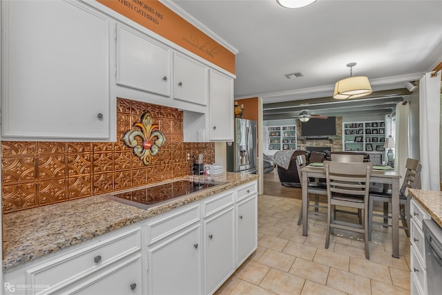 kitchen with ornamental molding, electric cooktop, visible vents, and white cabinetry