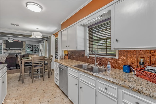 kitchen with a fireplace, a sink, decorative backsplash, dishwasher, and crown molding