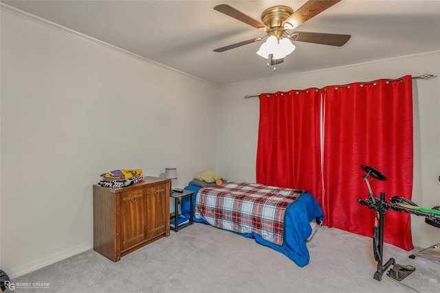 carpeted bedroom with a ceiling fan and baseboards