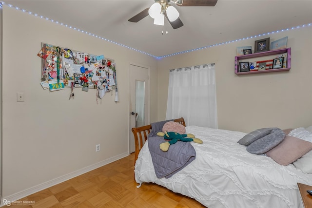 bedroom with a ceiling fan and baseboards