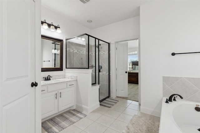 full bath with a stall shower, tile patterned flooring, a garden tub, and vanity