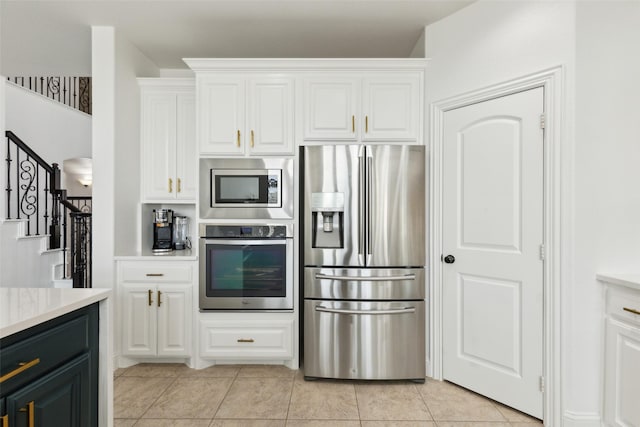 kitchen with white cabinets, appliances with stainless steel finishes, and light countertops