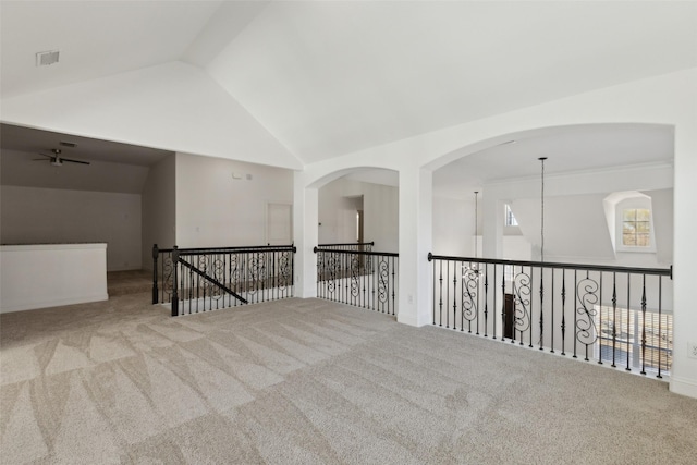 carpeted empty room featuring high vaulted ceiling and visible vents