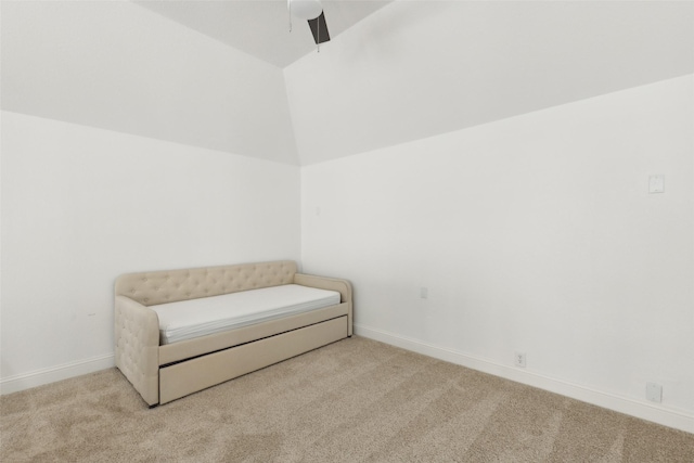 living area with lofted ceiling, ceiling fan, carpet, and baseboards