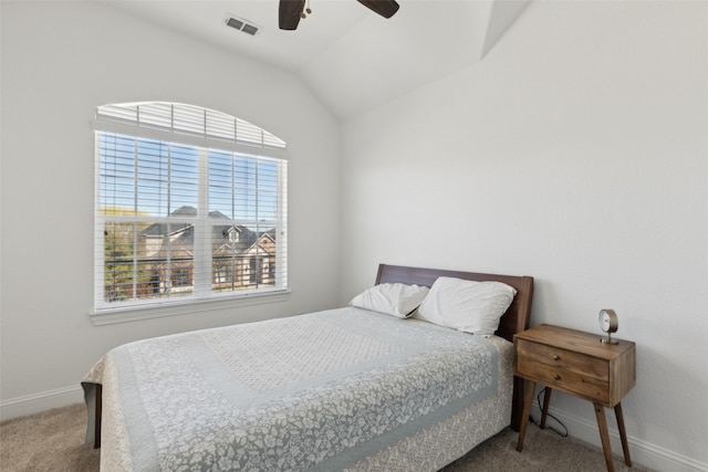 carpeted bedroom with lofted ceiling, ceiling fan, visible vents, and baseboards