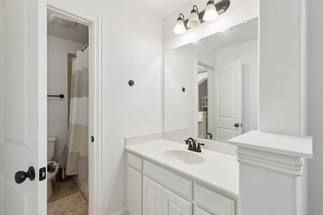 bathroom featuring visible vents, toilet, vanity, a shower with curtain, and tile patterned floors