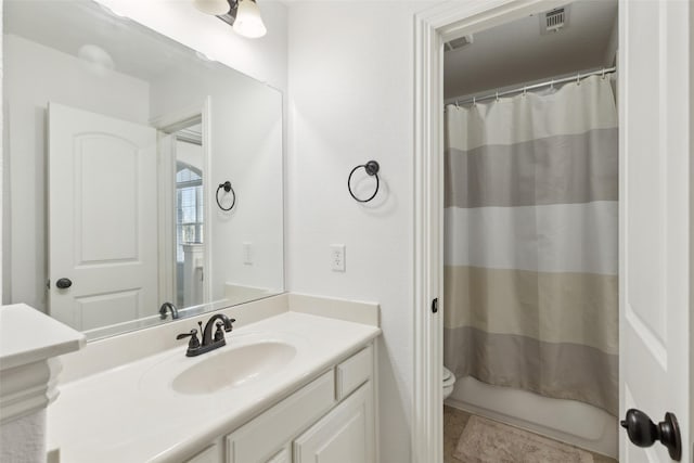 bathroom with toilet, tile patterned flooring, visible vents, and vanity