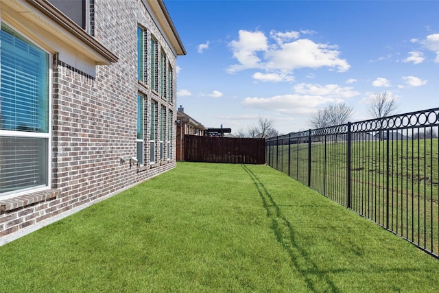 view of yard with a fenced backyard