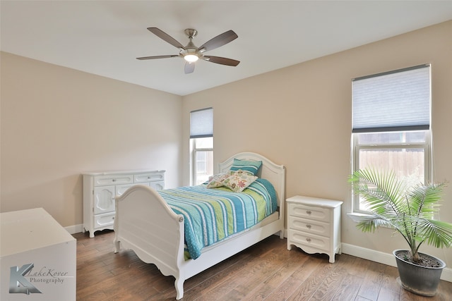 bedroom featuring a ceiling fan, baseboards, and hardwood / wood-style floors