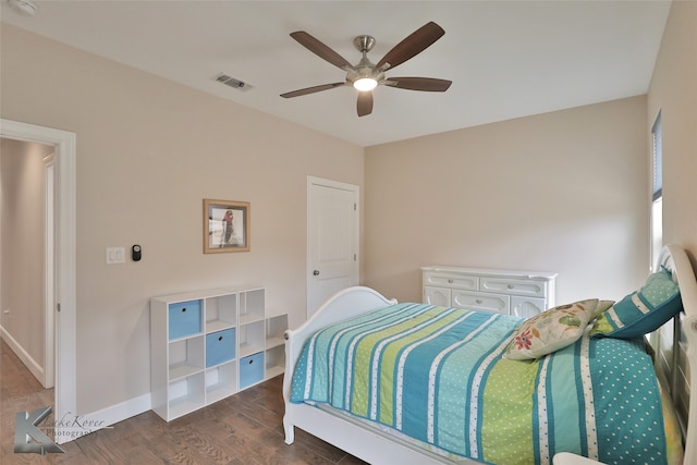 bedroom with a ceiling fan, baseboards, visible vents, and wood finished floors