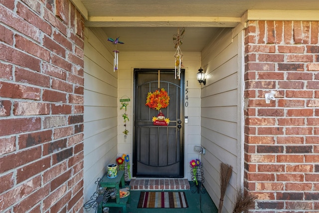 entrance to property with brick siding