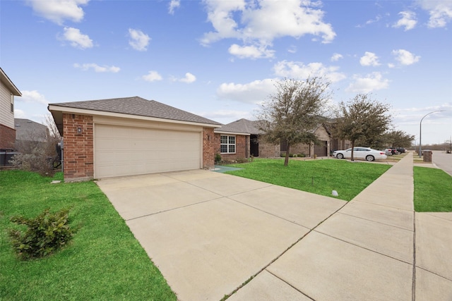 view of front facade featuring an attached garage, brick siding, a shingled roof, concrete driveway, and a front lawn