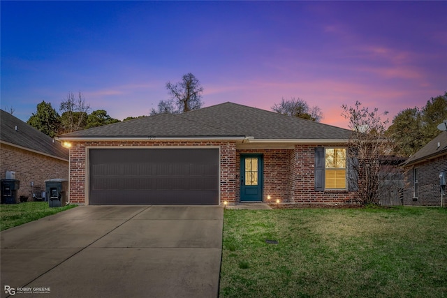 single story home featuring brick siding, a shingled roof, a lawn, an attached garage, and driveway