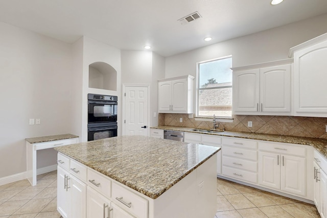 kitchen with dobule oven black, visible vents, dishwasher, a sink, and backsplash