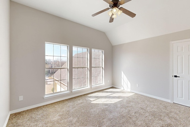 unfurnished room featuring a ceiling fan, carpet, vaulted ceiling, and baseboards