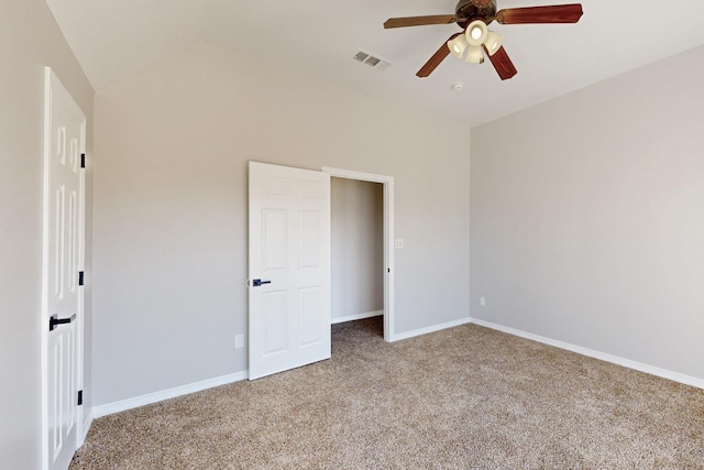 unfurnished bedroom with lofted ceiling, ceiling fan, carpet flooring, visible vents, and baseboards