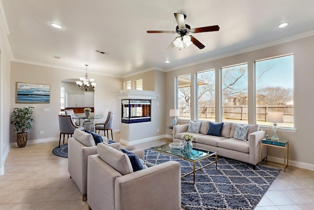 living room with light tile patterned floors, baseboards, visible vents, ornamental molding, and a multi sided fireplace