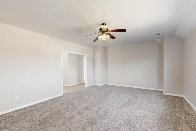 unfurnished room with carpet, lofted ceiling, visible vents, ceiling fan, and baseboards