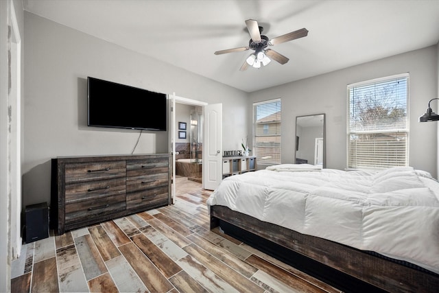 bedroom with ensuite bathroom, ceiling fan, and wood finished floors