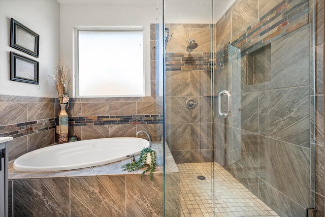 bathroom featuring a stall shower and a bath