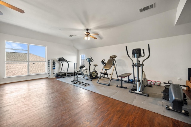 workout area with visible vents, vaulted ceiling, a ceiling fan, and wood finished floors