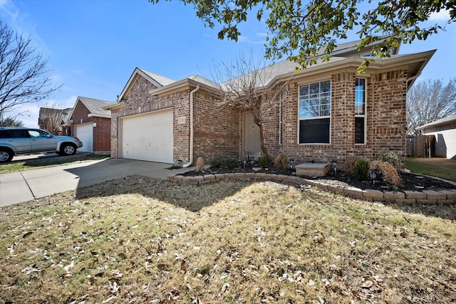 single story home featuring an attached garage, concrete driveway, and brick siding