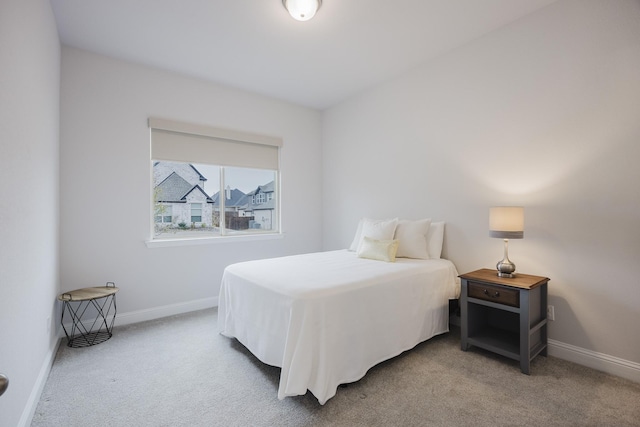 carpeted bedroom with baseboards