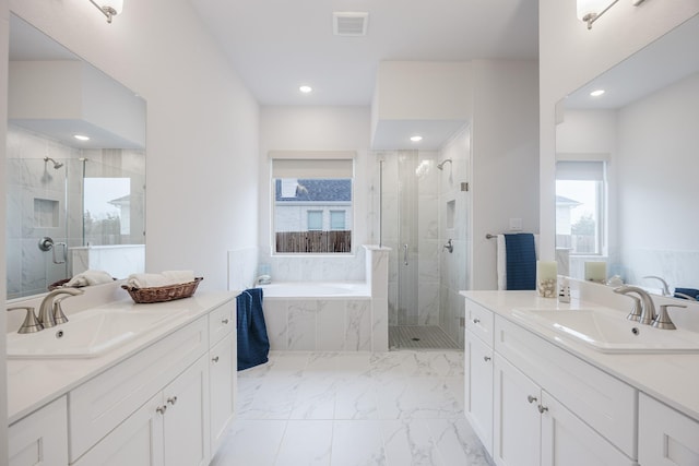 full bathroom featuring a bath, a stall shower, and a sink