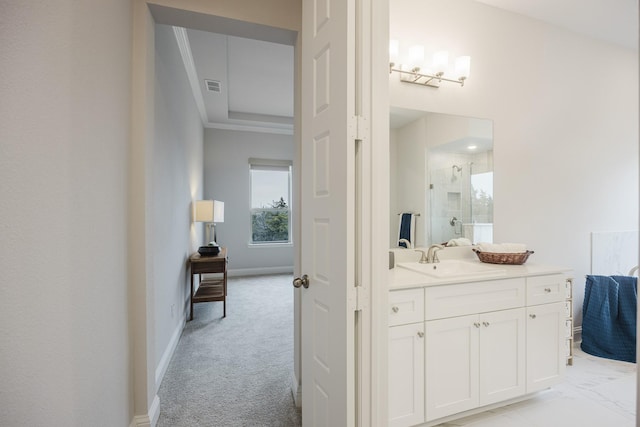 bathroom with visible vents, baseboards, ornamental molding, vanity, and a shower stall