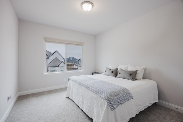 carpeted bedroom featuring baseboards