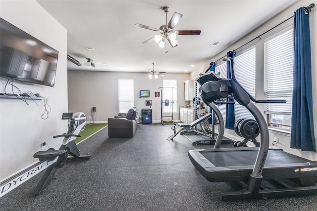 workout area featuring visible vents, baseboards, and a ceiling fan