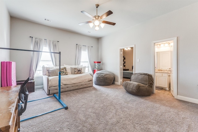 interior space featuring visible vents, ensuite bathroom, carpet flooring, ceiling fan, and baseboards