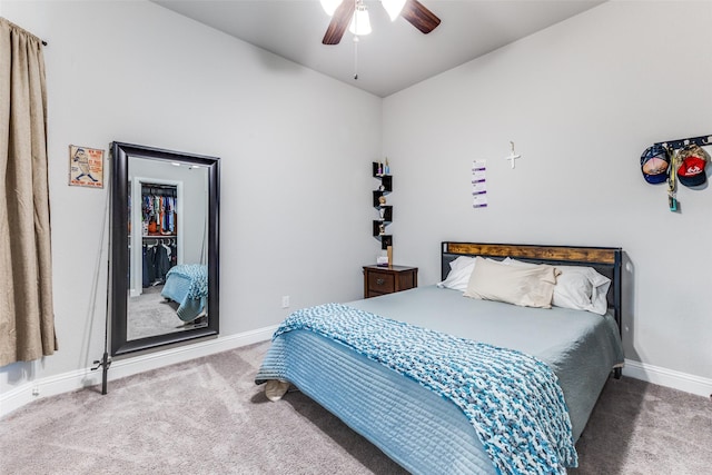 bedroom with ceiling fan, carpet flooring, and baseboards