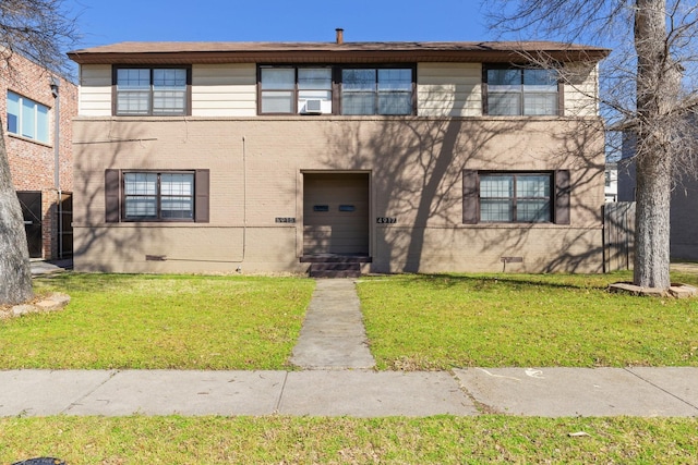 view of front facade with a front lawn, crawl space, and brick siding