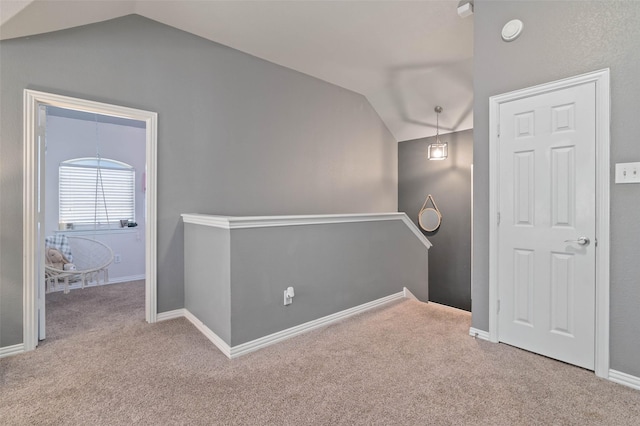 interior space with baseboards and vaulted ceiling