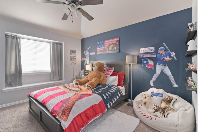 carpeted bedroom with ceiling fan, baseboards, and vaulted ceiling