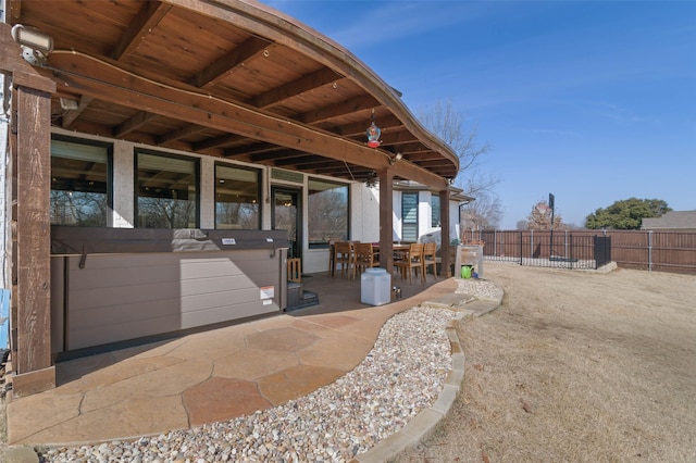 exterior space featuring outdoor dining area and fence