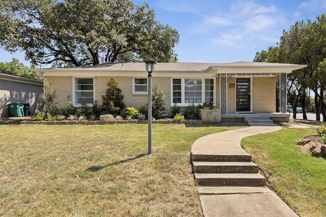 view of front of home with a front yard and brick siding