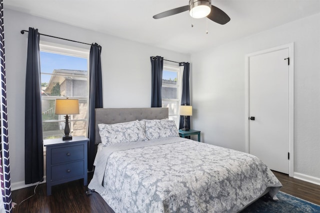 bedroom featuring ceiling fan, dark wood finished floors, and baseboards