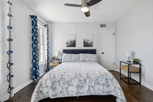 bedroom with dark wood-style floors, baseboards, visible vents, and ceiling fan