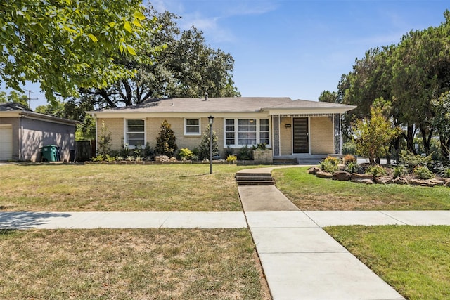 view of front of property with brick siding and a front yard