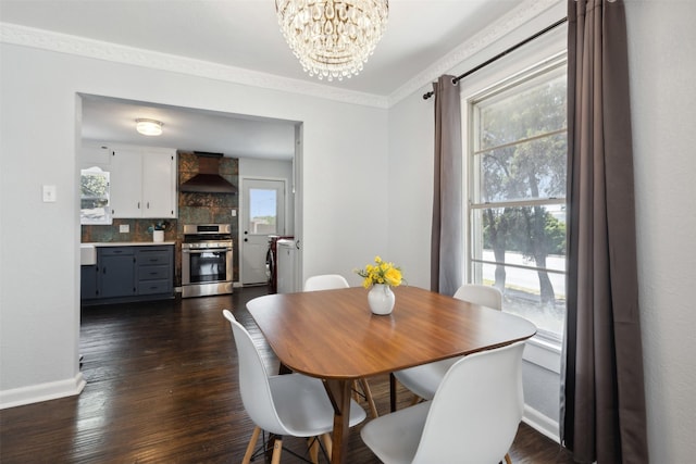 dining space featuring ornamental molding, dark wood-type flooring, plenty of natural light, and separate washer and dryer