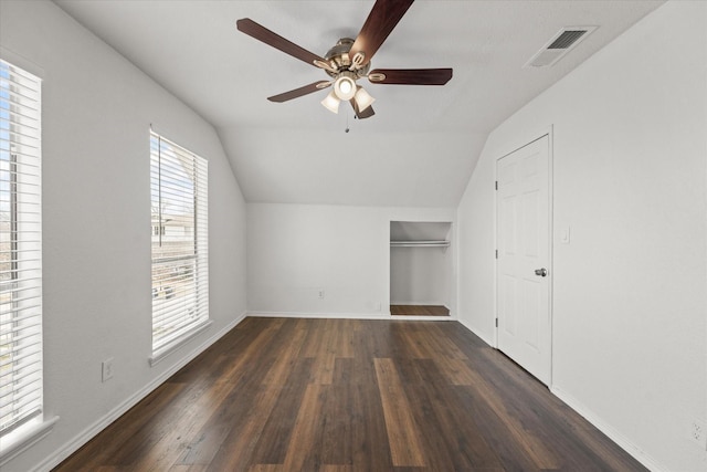 unfurnished bedroom with lofted ceiling, wood finished floors, visible vents, and baseboards