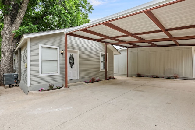 exterior space with a carport and central air condition unit