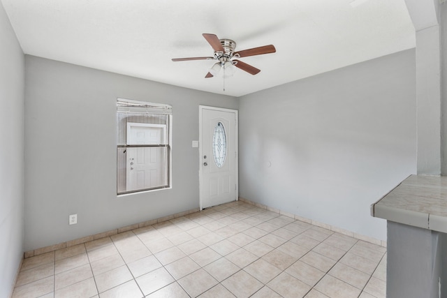 foyer with light tile patterned floors and a ceiling fan